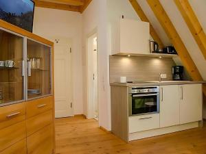 Una cocina con gabinetes blancos y un horno de estufa. en Auszeit beim Winzer- FeWo Idig, en Neustadt an der Weinstraße