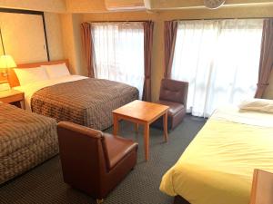 Postel nebo postele na pokoji v ubytování Business Inn Sennichimae Hotel