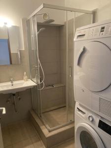 a bathroom with a washing machine and a sink at RK living room in Darmstadt
