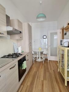 a kitchen with a stove top oven next to a table at Su e Giù Levante in Rapallo