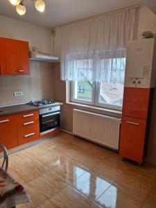 a kitchen with a stove and a large window at Garsoniera Luxury in Sibiu