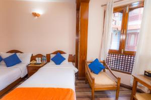 Voodi või voodid majutusasutuse Amber Royel Hotel toas