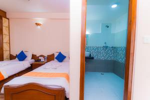 Voodi või voodid majutusasutuse Amber Royel Hotel toas