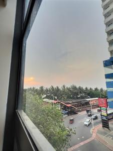 a view from a train window of a parking lot at Pearly Breeze Guest Room in Dehiwala