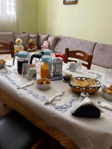 a table with food and drinks on top of it at Luigi Guest House in Gjirokastër