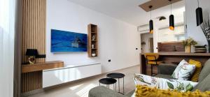 a living room with a couch and a table at GREEN cozy apartment with shared POOL in Split