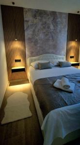a bedroom with two beds with towels on them at GREEN cozy apartment with shared POOL in Split +18 photos