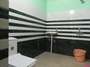 a bathroom with a sink and a toilet at Riddhi Siddhi Homestay in Bhīm Tāl