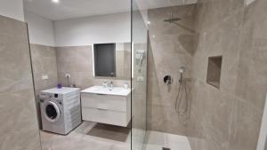 a bathroom with a shower and a washing machine at Canaletto Apartment Rialto in Venice +20 photos