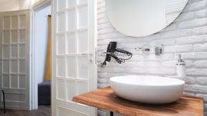 a bathroom with a white sink and a mirror at Gira e Firria in Palermo +70 photos