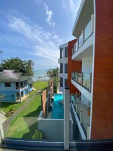 a view from the balcony of a house with a swimming pool at Beachfront in Ban Lum Fuang