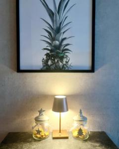 a lamp on a table with a picture of a pineapple at AllgäuLoft im Sennhof in Weiler-Simmerberg