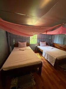 a bedroom with two beds in a tent at Sweet View Guesthouse in Kaôh Rŭng (3) +137 photos
