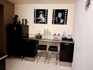 a kitchen with a counter with bar stools in it at Residentie Ruytingen in Ostend