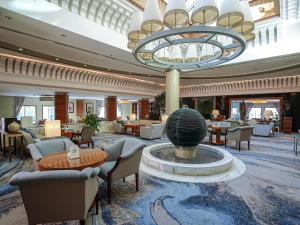 a lobby of a hotel with a fountain in the middle at Sheraton Dammam Hotel & Convention Centre in Dammam