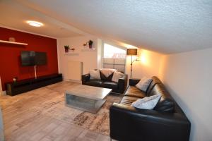 a living room with a couch and a table at FeWo Landkirchen 2 in Fehmarn