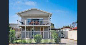 a house with a fence in front of it at Riverside Kingdom Goolwa in Goolwa