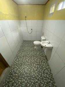 a bathroom with a toilet and a sink at Gunung baru homestay in Senaru +30 photos