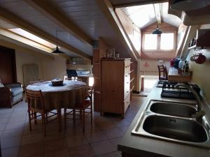 a kitchen with a table and a kitchen with a sink at Appartamento centro storico in Riva del Garda