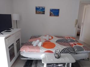 a small bedroom with a bed and a tv at Casa Francesca in Cavigliano
