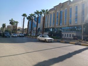 a car parked in a parking lot in front of a building at 378 Pyramids St -Two bedrooms Hotel Apartment in Cairo