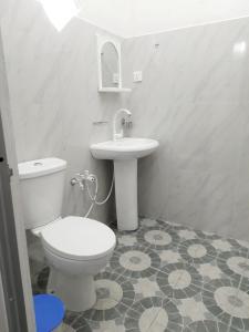 a bathroom with a white toilet and a sink at Black Rose Guest in Gampaha +29 photos