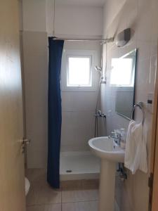 a bathroom with a sink and a shower with a window at Napa Charles Apts in Ayia Napa +17 photos
