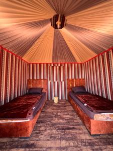 a bedroom with two beds in a tent at Bedouin Nature Camp in Wadi Rum