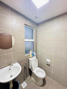 a bathroom with a white toilet and a sink at Embun Homestay Puchong SemiD 1-10Pax 6-7CarPark in Puchong +27 photos
