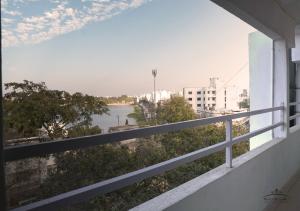 a view of a river from a balcony at Prince Residency in Jamnagar