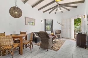 a living room with a wooden table and chairs at 19 Casa Peces in Kralendijk
