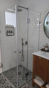 a shower with a glass door in a bathroom at בית האורחים - צימר גלילי בין שדות ונחלים in Sede Neẖemya +25 photos