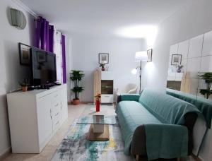 a living room with a couch and a tv at Villa SunShine Ciudad Quesada Spain in Ciudad Quesada