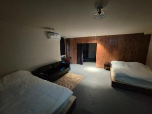 a bedroom with a bed and a couch in it at STUDIO BIS Licensed jeonpo Cafe street King beds 3-min subway in Busan