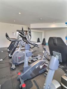 a gym with several cardio machines in a room at Pearly Ocean View Suite in Dehiwala