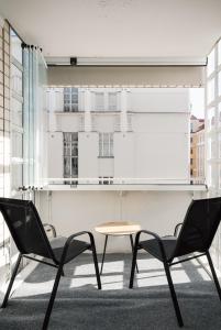 a table and two chairs in a room with a window at 1BR City Apartment with Balcony Next to the Sea in Helsinki +29 photos