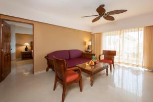a living room with a purple couch and a table at Occidental Caribe - All Inclusive in Punta Cana