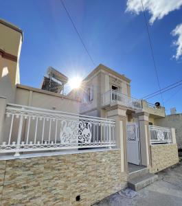 a house with a balcony with the sun shining on it at Elia Old Mansion in Malona Village
