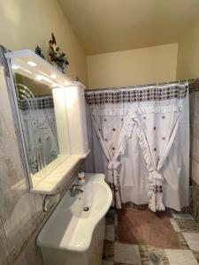 a bathroom with a sink and a shower curtain at Elia Old Mansion in Malona Village +34 photos