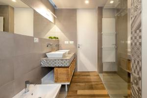 a bathroom with two sinks and a mirror at CASA ANTO - Charming apartment 50 meters from the beach in Alghero
