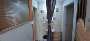 a bathroom with a shower with a sink and a toilet at Apartment Simple Center in Ohrid +10 photos