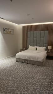 a bedroom with a large bed in a room at Alula Oasis1 in AlUla +19 photos