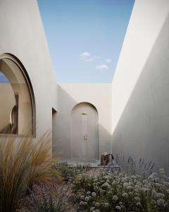 a church with white walls and white flowers at Vouno in Pirgos