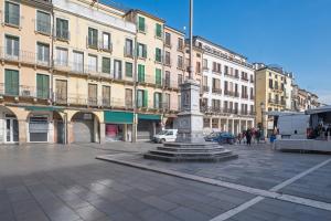 a statue in the middle of a street with buildings at Diamantino Town House in Padova
