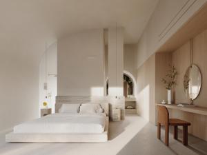 a bedroom with a large white bed and a table at Vouno in Pirgos
