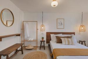 a bedroom with two beds and a bench and a mirror at Solaya Kineret in Migdal