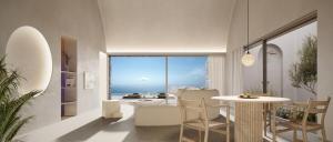 a dining room with a table and a view of the ocean at Vouno in Pirgos