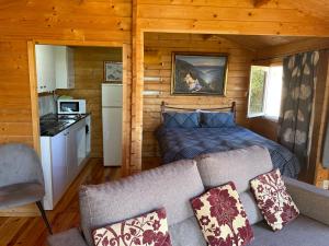a living room with a bed and a couch in a cabin at PlayaArco Escullos in Los Escullos