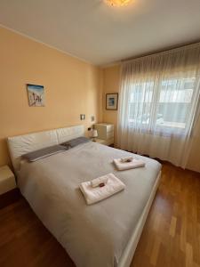 Un dormitorio con una cama grande con toallas. en Daisy house, en Trieste