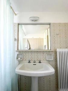 a bathroom with a white sink and a mirror at Beachfront Family Villa in Eretria +48 photos